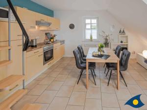 a kitchen and dining room with a table and chairs at Fraeulein Loddin Whg_ Ole in Kölpinsee +33 photos