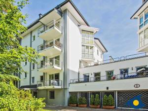 an exterior view of a white building with balconies at Villa Strandperle Whg 07 in Bansin