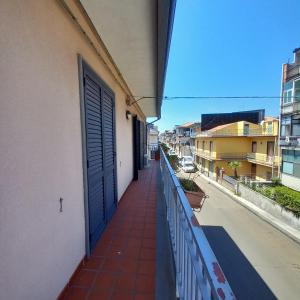 a balcony with a blue door on a building at New Magnolia House in Belpasso +12 photos