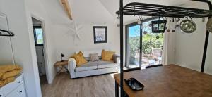 a living room with a couch and a table at Cabane Cozy & Calme in Janville