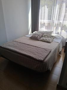 a bed in a room with a large window at Studio Benal Iris in Málaga +4 photos