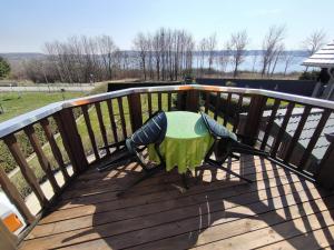 a wooden deck with a green table on it at Ferienhaus Concordiasee in Friedrichsaue