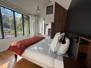 a bedroom with a bed and a large window at La Maison d'Amboise in Amboise