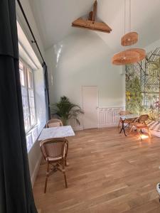 an empty room with chairs and tables and windows at La Maison d'Amboise in Amboise +23 photos