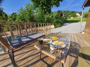 a table with a tray of food on a deck at Cabane Cozy & Calme in Janville
