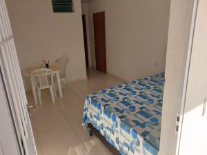 a bedroom with a bed and a table and chairs at Angelsuites in Maceió +8 photos