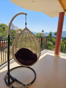 a hanging hammock on a balcony with a view at Rahini sunset villa in Shimla