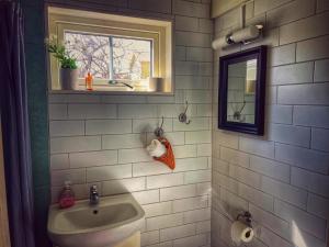 a bathroom with a sink and a window at Stuga smögen in Smögen