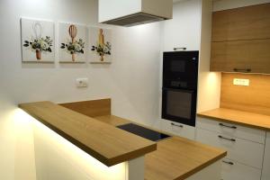 a kitchen with a counter top and a microwave at Apartma Šmarnica in Slap ob Idrijci +13 photos