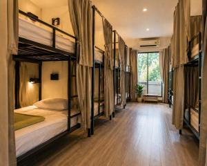 a group of bunk beds in a room at HideSeek Hostel Vientiane Thai embassy in Vientiane