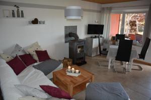 a living room with a couch and a wood stove at Ferienhaus Abendrot in Basedow