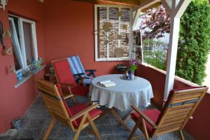 a porch with a table and chairs on it at Ferienhaus Abendrot in Basedow