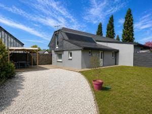 a small white house with a patio and a yard at Camping de la Baie-Baie de Somme-Sites et Paysages in Pendé