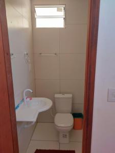 a small bathroom with a toilet and a sink at Angelsuites in Maceió