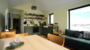 a living room with a table and a couch at Bárucottage in Eyrarbakki