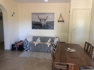 a living room with a couch and a cow on the wall at Casa Roberta a Lucca in Lucca