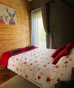 a bedroom with a bed with a red and white blanket at Czerwona Stodoła Karkonoska in Podgórzyn +51 photos