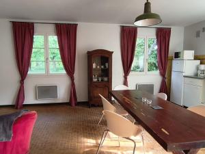 a dining room with a wooden table and chairs at Aubrion de Cremens in Magnan