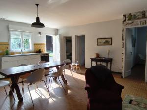 a kitchen and dining room with a table and chairs at Aubrion de Cremens in Magnan +11 photos