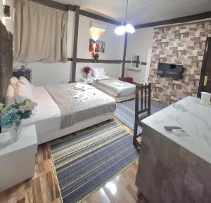 a hotel room with two beds and a television at Dawn tawn velavet in Cairo