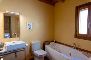 a bathroom with a sink and a toilet and a tub at Ca la Bepa in Rocafort de Vallbona +9 photos
