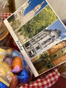 a book on a table with a picture of a building at La Maison de Traverse in Vichy