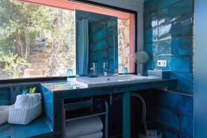 a blue bathroom with a sink and a mirror at Le Jardin d'Emile in Cassis +56 photos