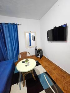 a living room with a blue couch and a table at Vince Saly in Saly Portudal