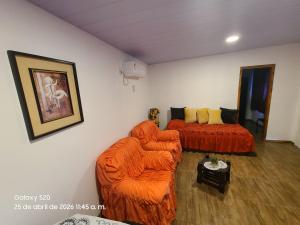 a living room with two chairs and a couch at Refugio del Horizonte Colonia in Colonia del Sacramento +8 photos