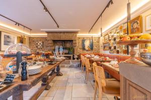 a restaurant with tables and chairs and a fireplace at Manoir Des Douets Fleuris in Cancale