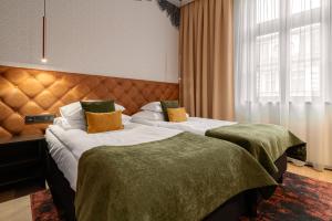 a hotel room with two beds and a window at Butikowy Hotel M23 Katowice Centrum in Katowice