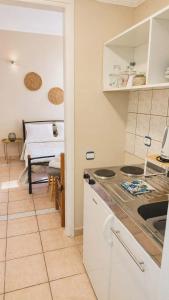 a kitchen with a table and a bed in a room at Pantelis Studio in Paralia Agias Foteinis