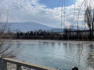 a view of a body of water with a fence at Quartier am Fluss - CityNest in Innsbruck +6 photos