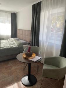 a room with a bed and a table with a candle on it at Quartier am Fluss - CityNest in Innsbruck