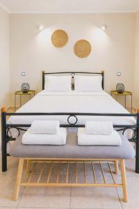 a bedroom with a bed with two pillows on it at Pantelis Studio in Paralia Agias Foteinis