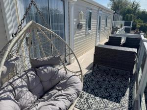 a porch with a hammock on a house at Anchor's Drop in Blue Anchor