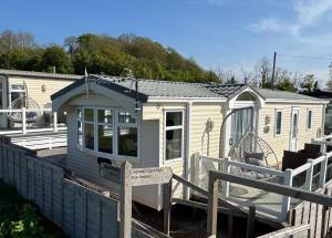 a tiny house with a sign in front of it at Anchor's Drop in Blue Anchor