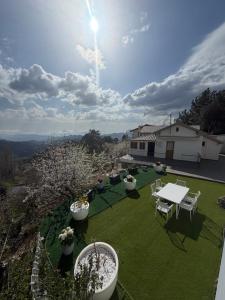 a view of a yard with a table and chairs at Petrovounos Villa in Prodromos