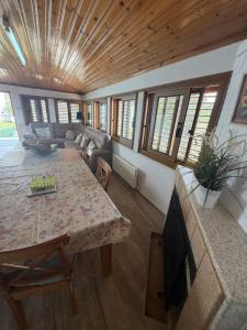 a living room with a table and a couch at Petrovounos Villa in Prodromos +13 photos