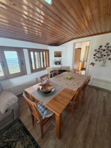 a dining room with a wooden table and chairs at Petrovounos Villa in Prodromos