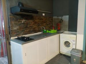 a kitchen with a sink and a washing machine at Z House Jbeil in Jbeil