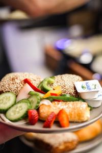a plate of food with vegetables and bread at HOTEL andrä in Salzburg