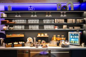 a kitchen with a counter with dishes and food at HOTEL andrä in Salzburg