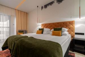 a bedroom with a large bed with a large headboard at Butikowy Hotel M23 Katowice Centrum in Katowice