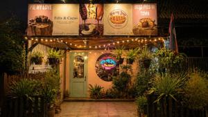 a front door of a restaurant with lights and plants at HideSeek Hostel Vientiane Thai embassy in Vientiane