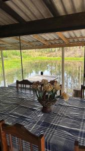 a table with a vase on top of it at Sítio Rio Lima in Rio Forcação