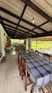 a large dining room with a table and chairs at Sítio Rio Lima in Rio Forcação