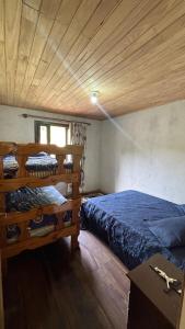 a bedroom with two beds and a wooden ceiling at Sítio Rio Lima in Rio Forcação