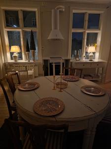a dining room table with four plates on it at Nordgrenska in Åmål
