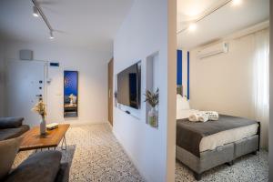 a bedroom with a bed and a living room at Noa Suite Hotel Only Adult in Bodrum City